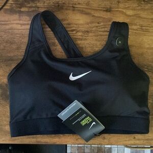Women’s black BNWT size medium sports bra.  See pictures for details $30 obo